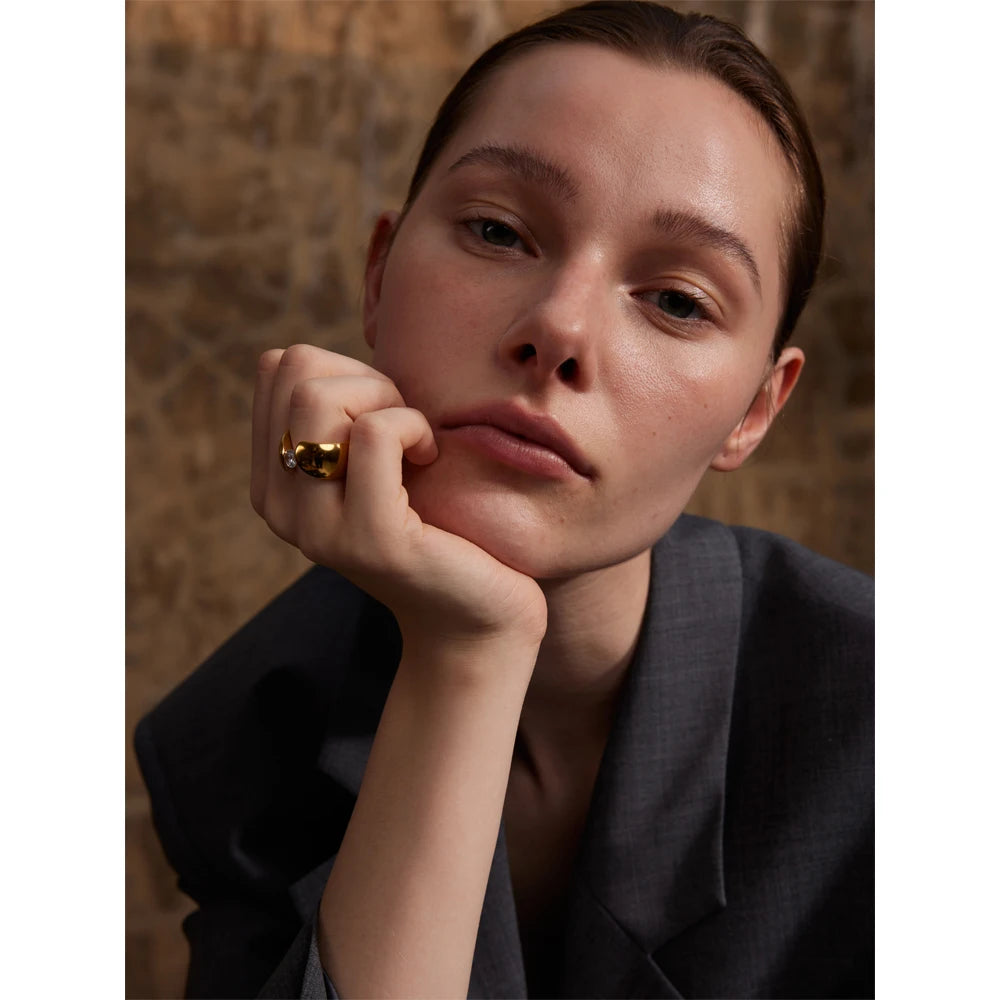 Wide ring with gold finish showcasing brilliant cubic zirconia