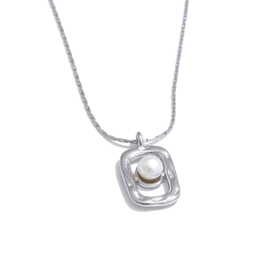 Pendant necklace featuring natural pearl and gold tone steel