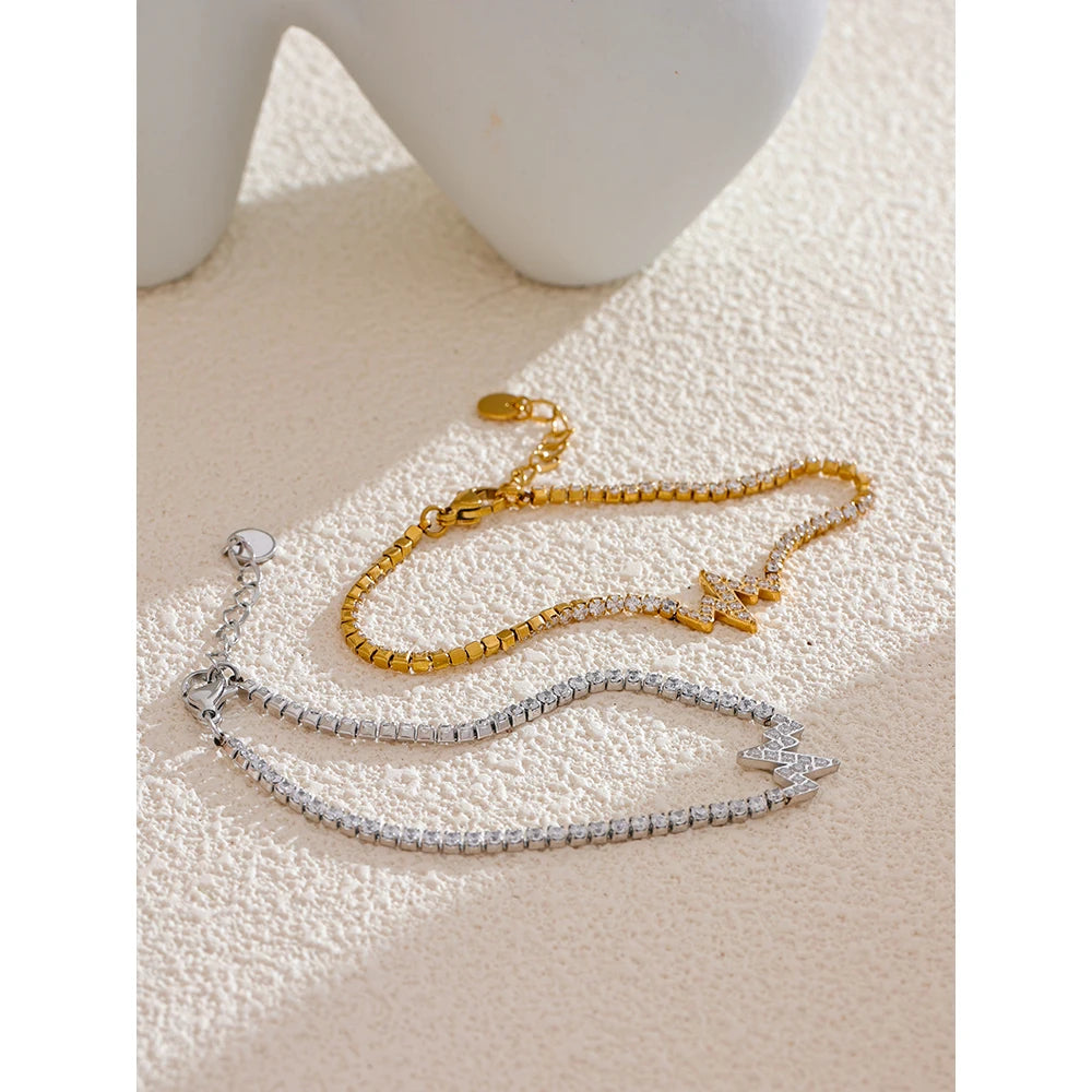 Charm and bracelet style featuring a gold chain bracelet in soft light