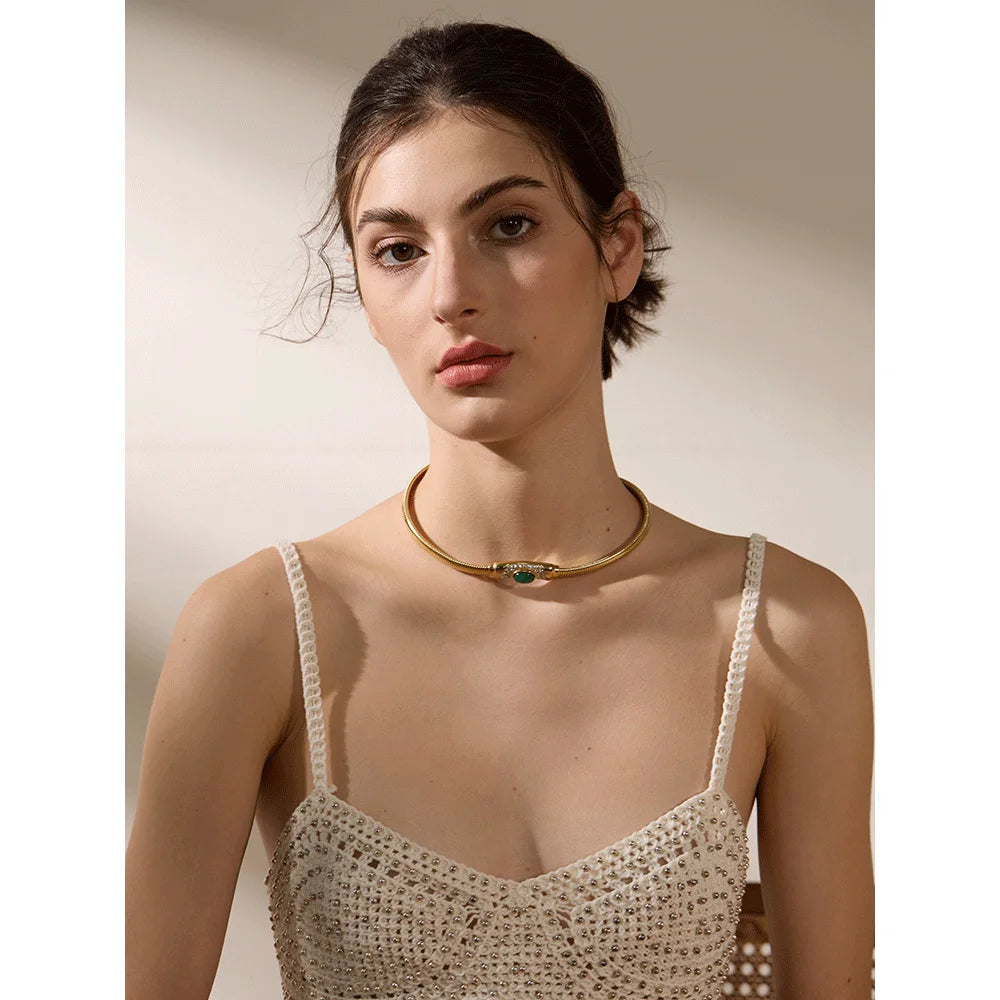 Close-up of green zircon central stone on gold chain choker