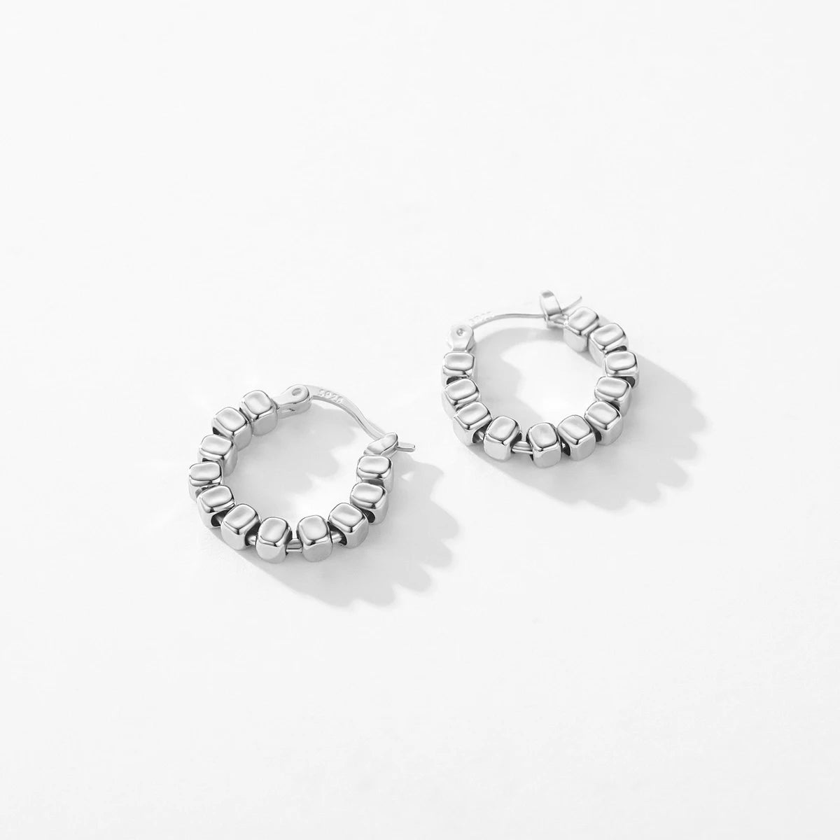Small silver hoop earrings with block design