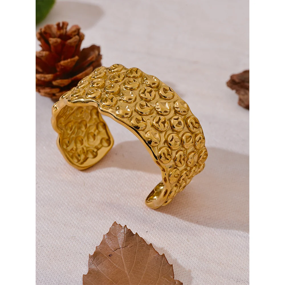 Close view of a metal bracelet with bangle bracelet lines and gold plated sheen