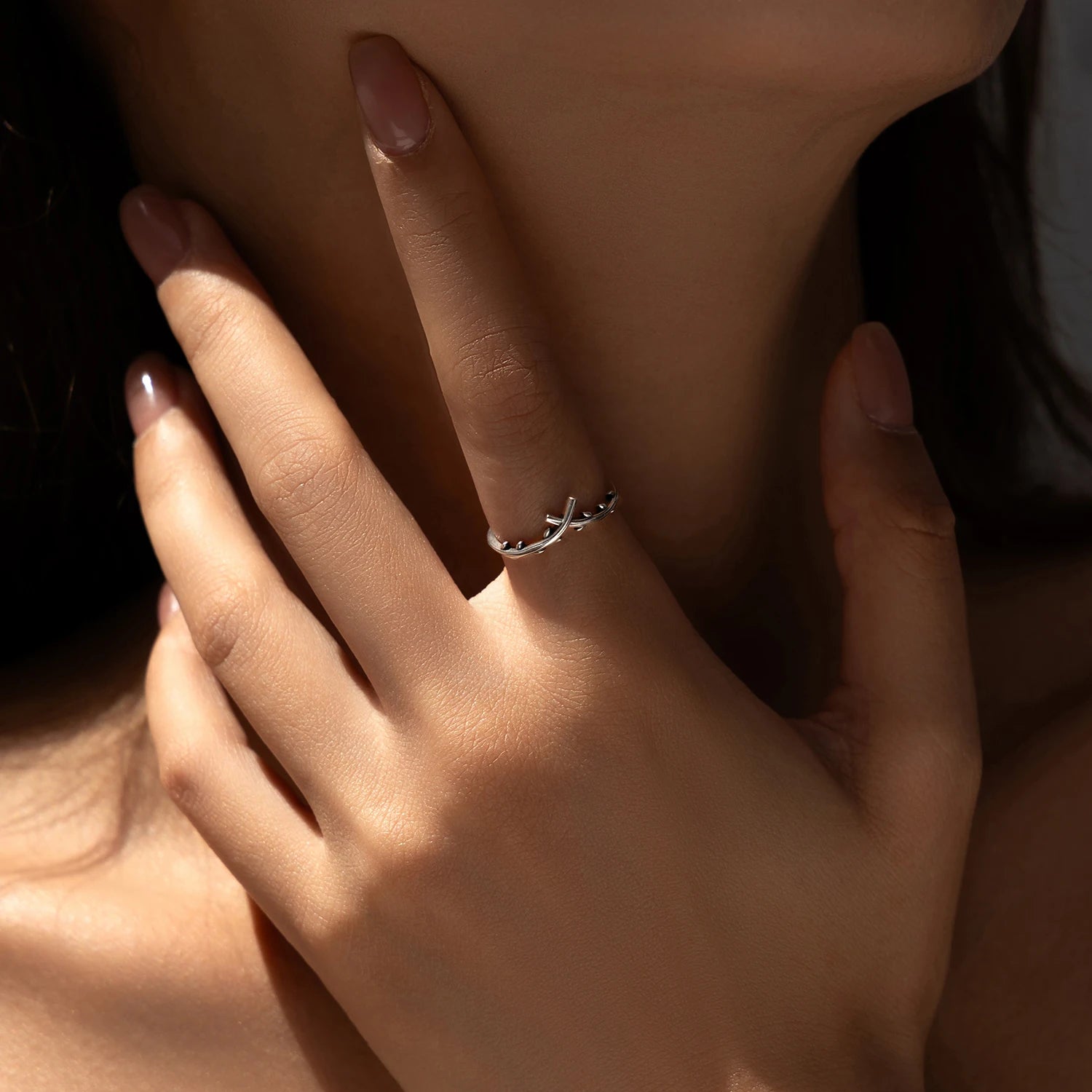 Close view of sterling silver ring showing subtle tree branch ring texture
