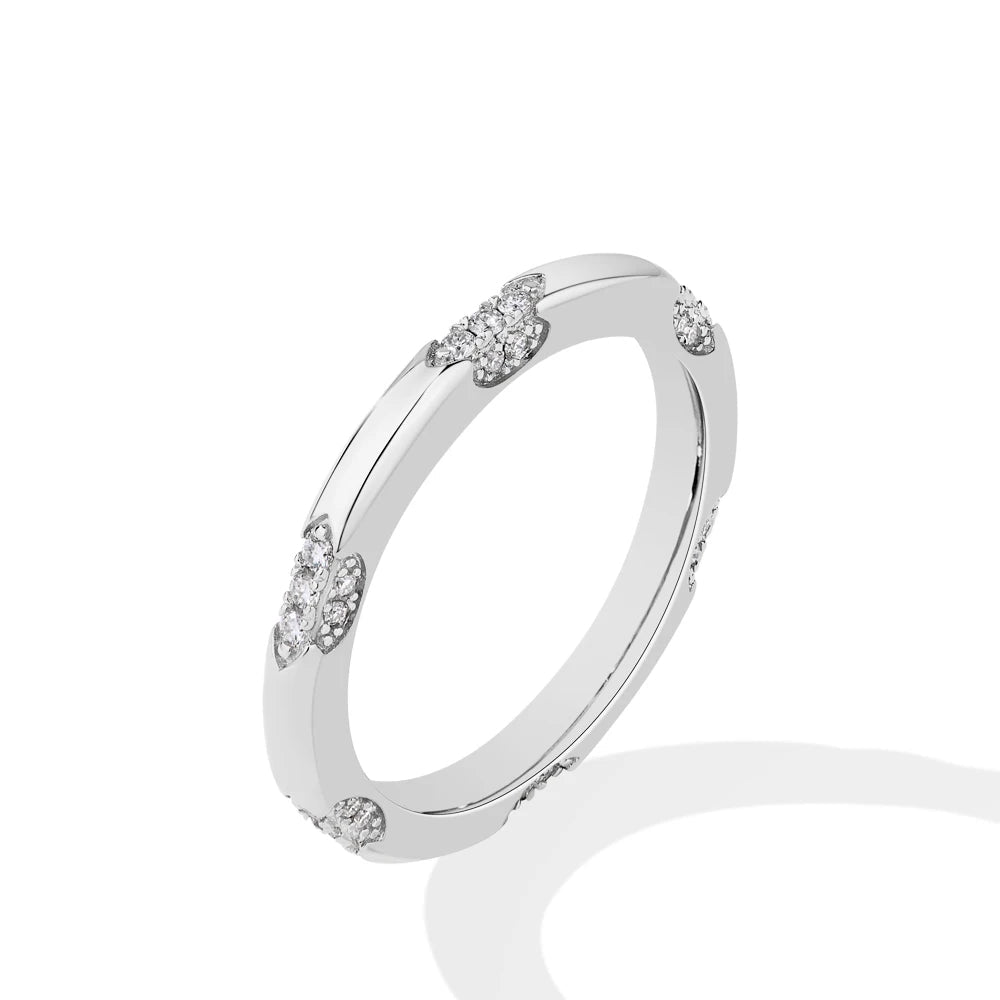 Wedding band with moissanite diamond beside a wedding ring
