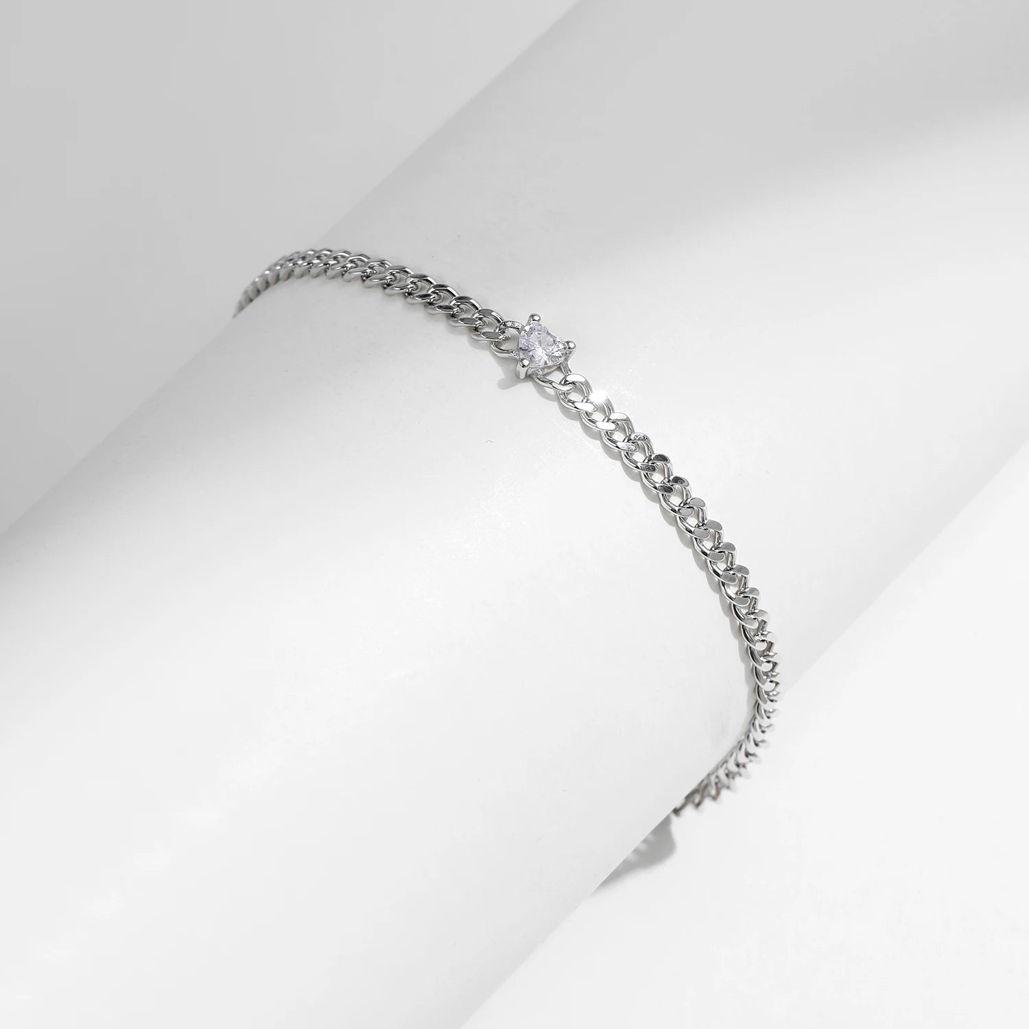 Silver bangle inspired chain bracelet featuring heart cz and silver color finish