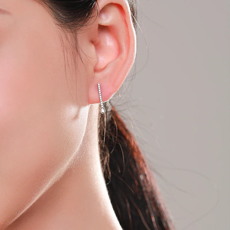 Close view of stud earrings with a polished 925 sterling silver finish