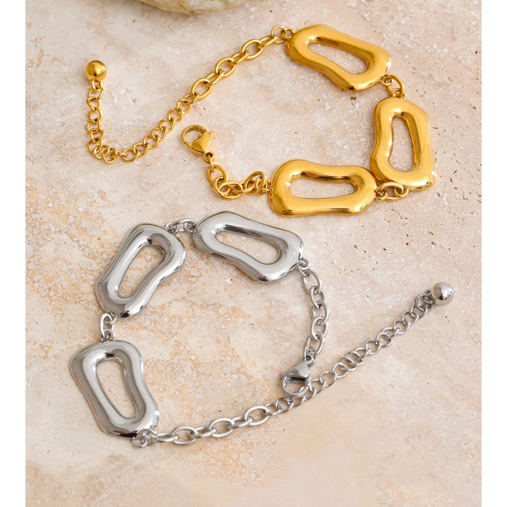 Close view of chain necklace links beside a matching bracelet chain