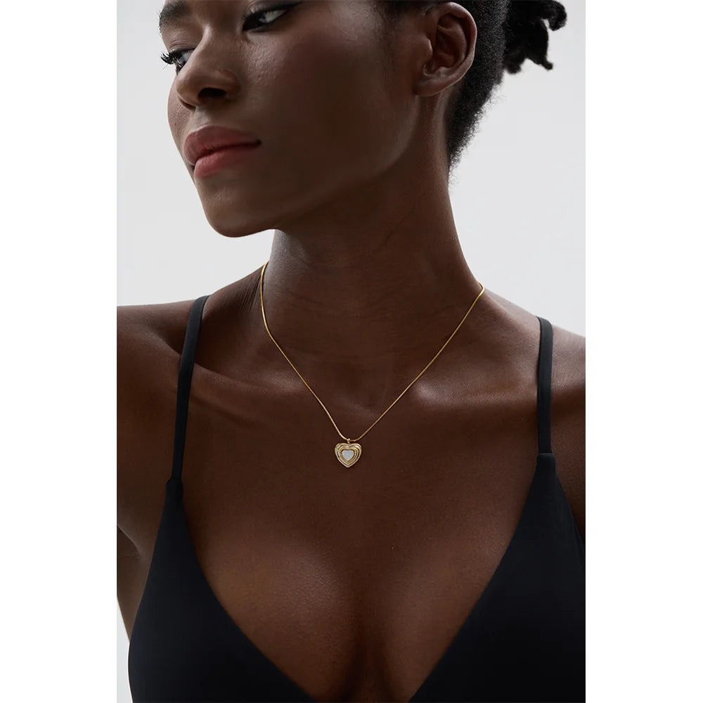 Heart necklace featuring a heart shell on a polished gold chain