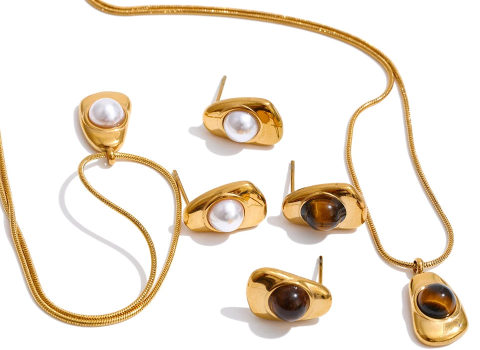 Fashion flat lay pairing necklace pearl necklace elements with gold plated tones