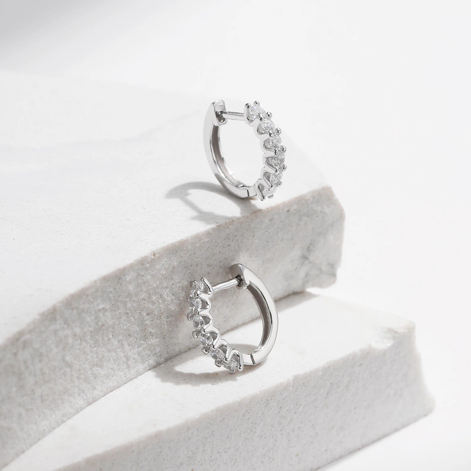 Silver hoops style featuring moissanite earrings detailing