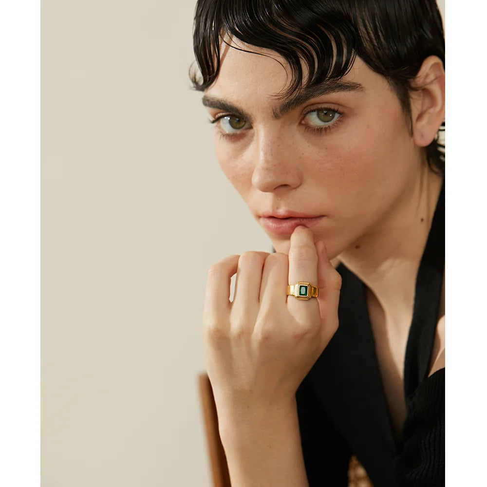 Close-up of cubic zirconia ring with green and white stones