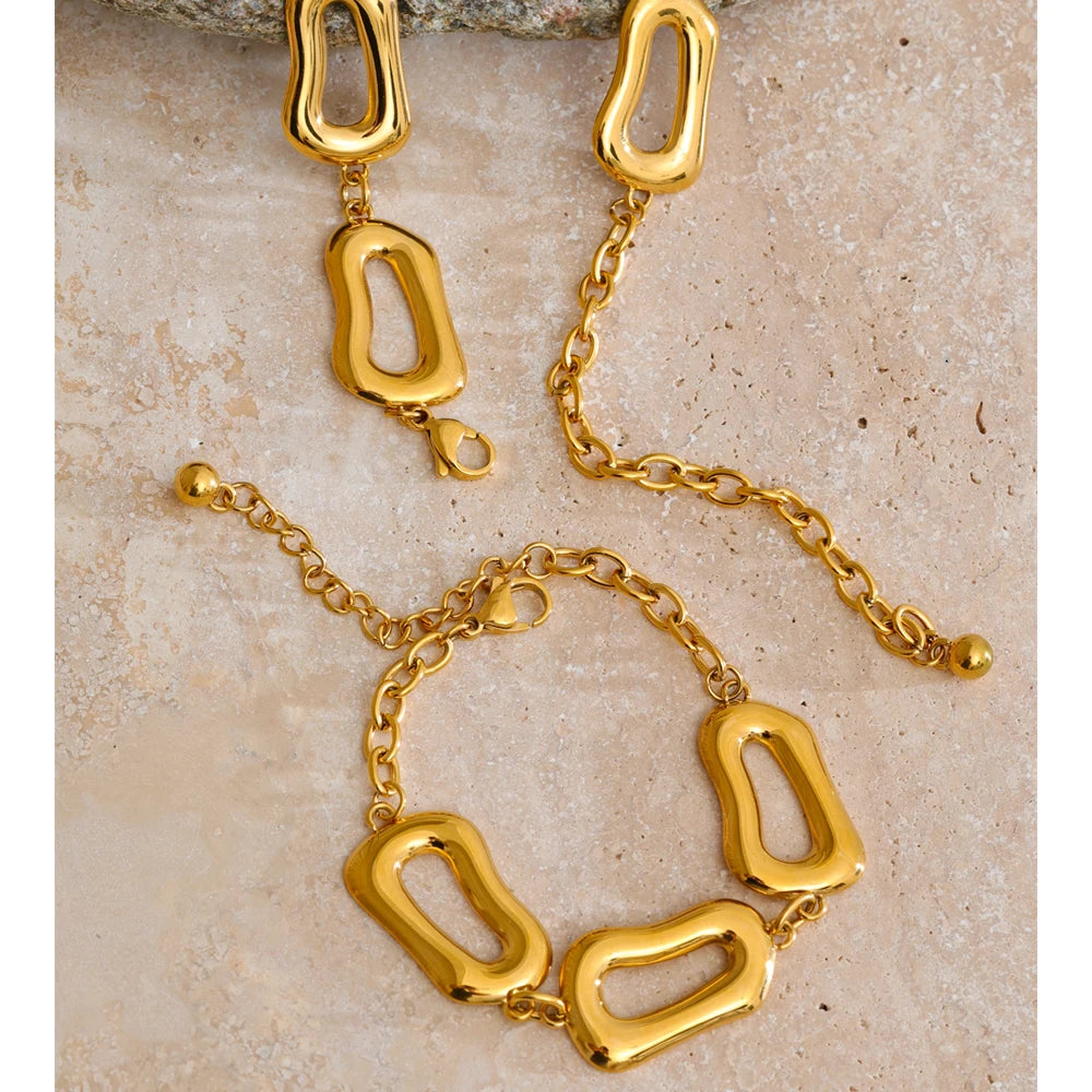 Minimal studio shot showing stainless steel jewelry shine on necklace and bracelet