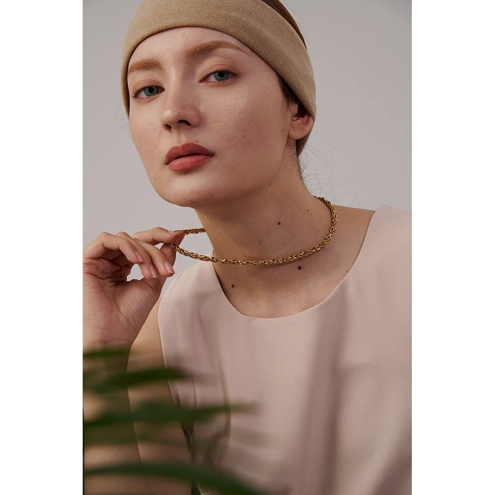 Necklace gold necklace arranged beside a gold chain gold bracelet charm