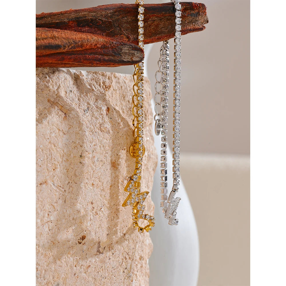 Minimal shot of bracelet charm bracelet beside gold a chain accents