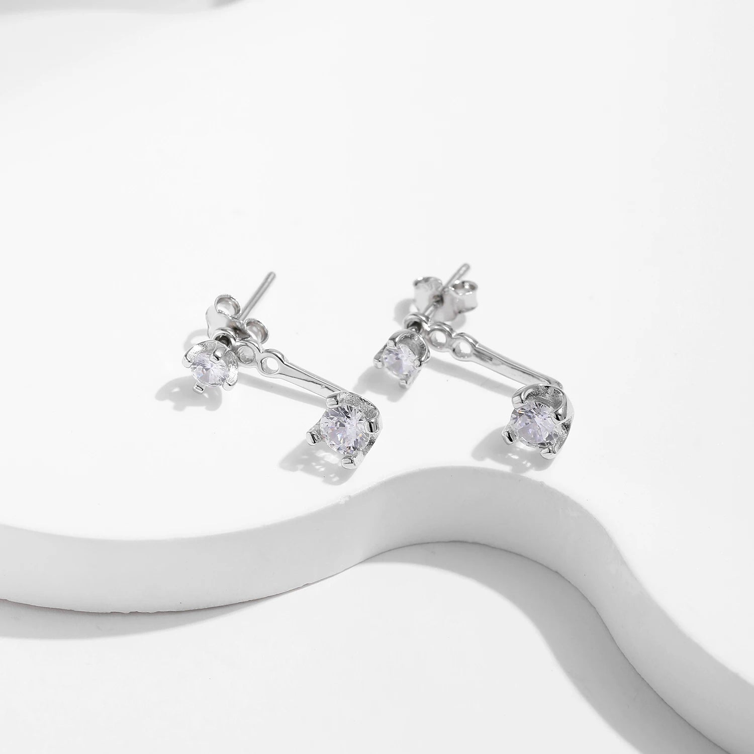 Minimal ear rings in silver color styled with 925 silver accents