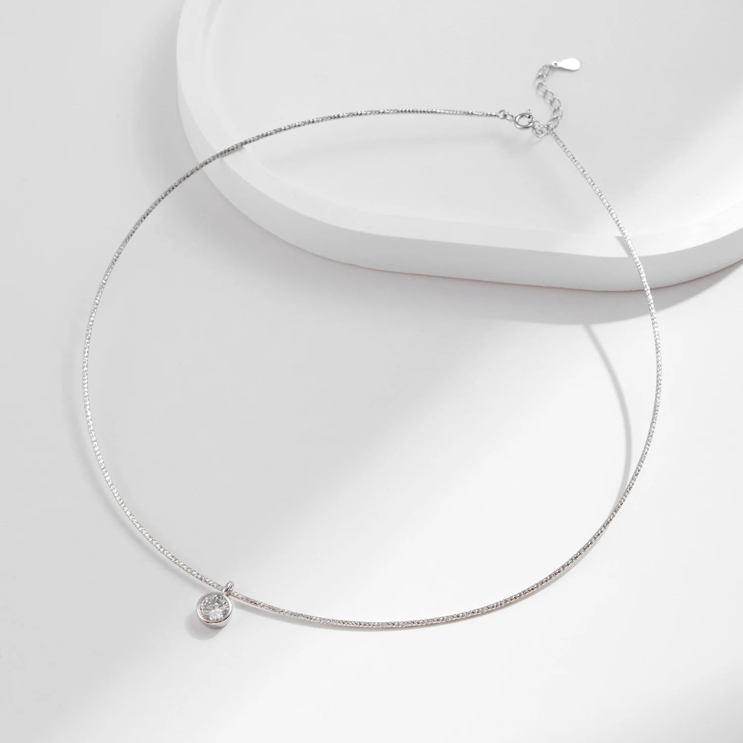 Choker necklace layer featuring a delicate cz on a slim snake chain