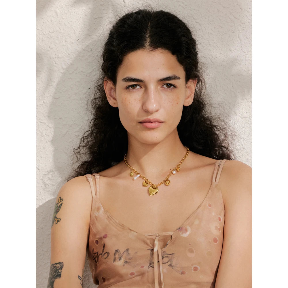 Layered necklace and necklace styling featuring heart jewelry accents