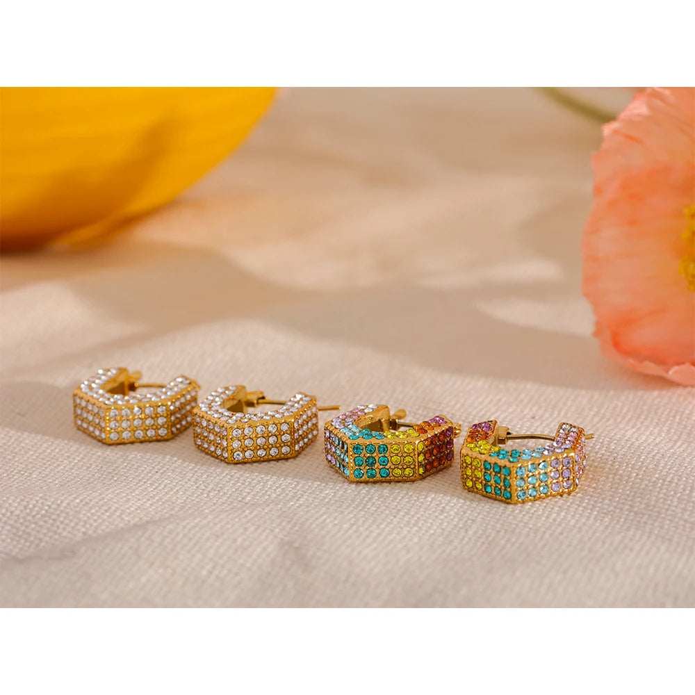 Gold hoop earrings highlighted as luxury jewelry with bright cubic zirconia