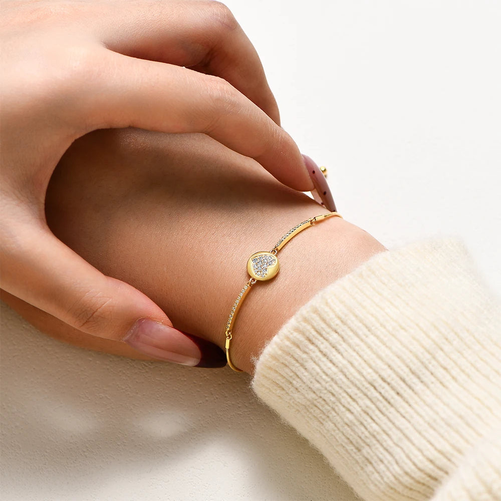 Charm style love bracelet beside a bracelet gold bracelet stack