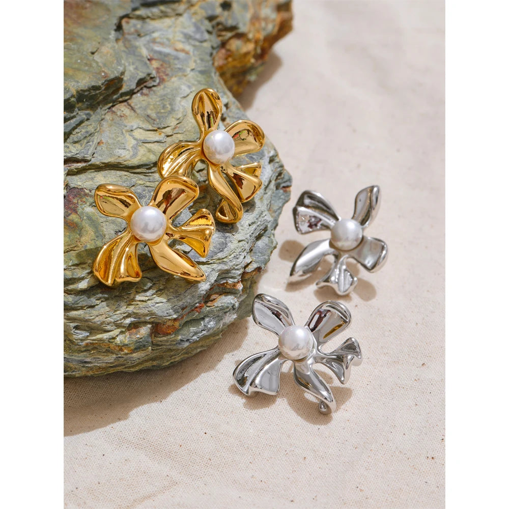 Minimal shot of gold jewelry flower earrings and subtle shine