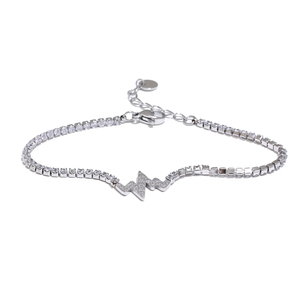 Chain and bracelet flat lay highlighting cubic zirconia and gold and chain