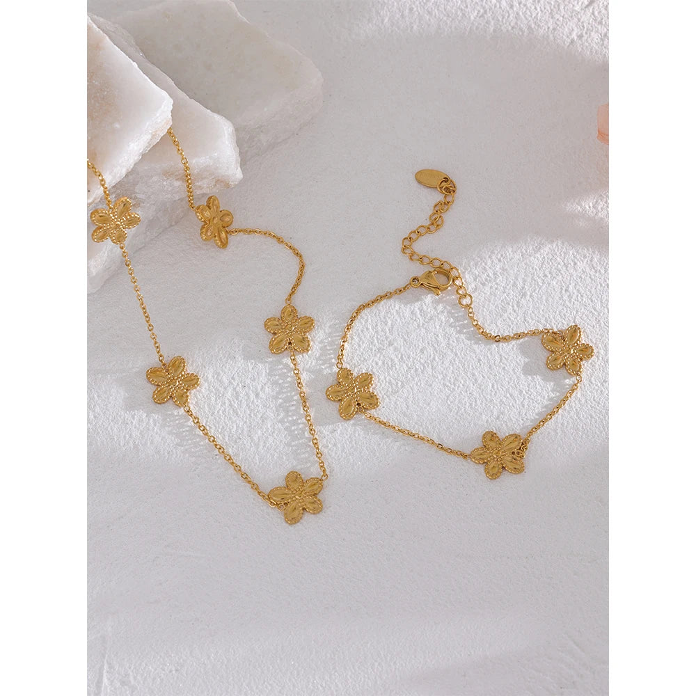 Elegant gold and necklace combination with flower motifs