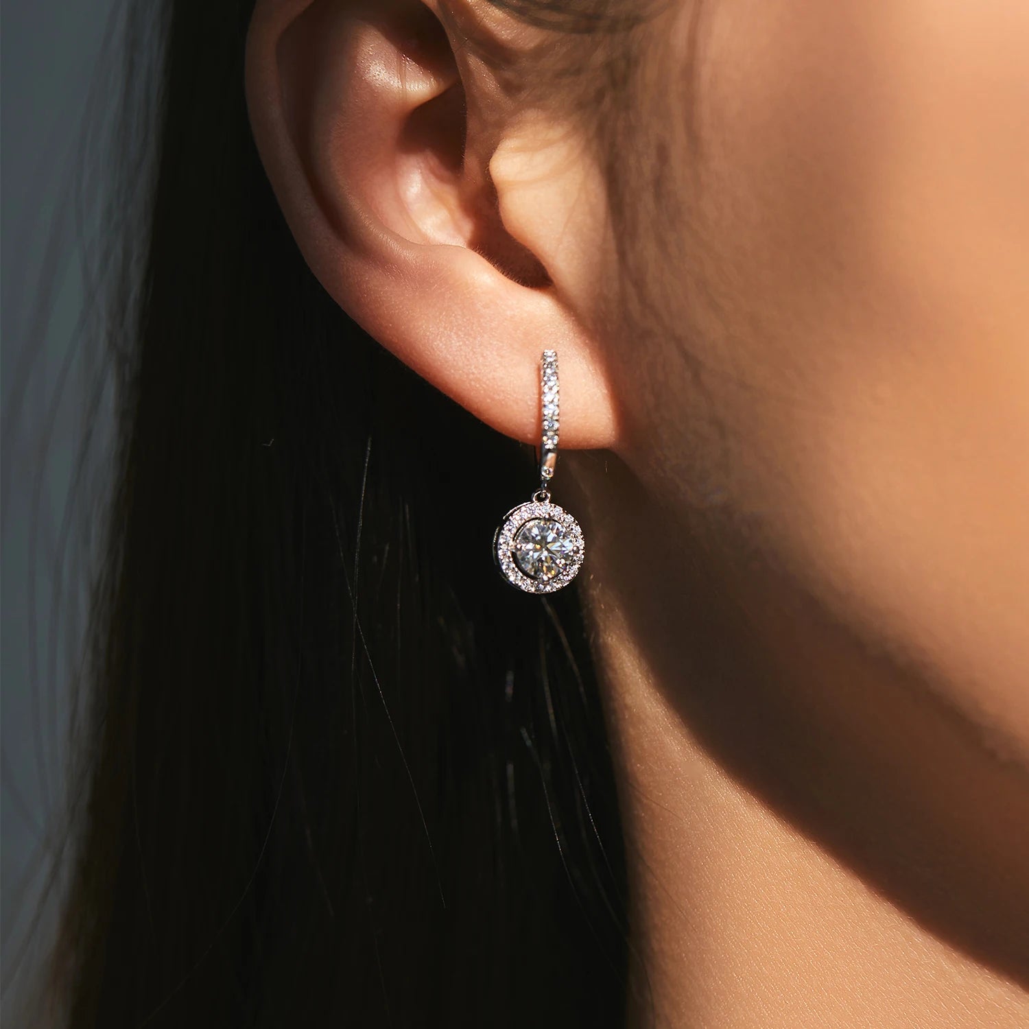 Drop earrings paired with silver hoops for a layered look