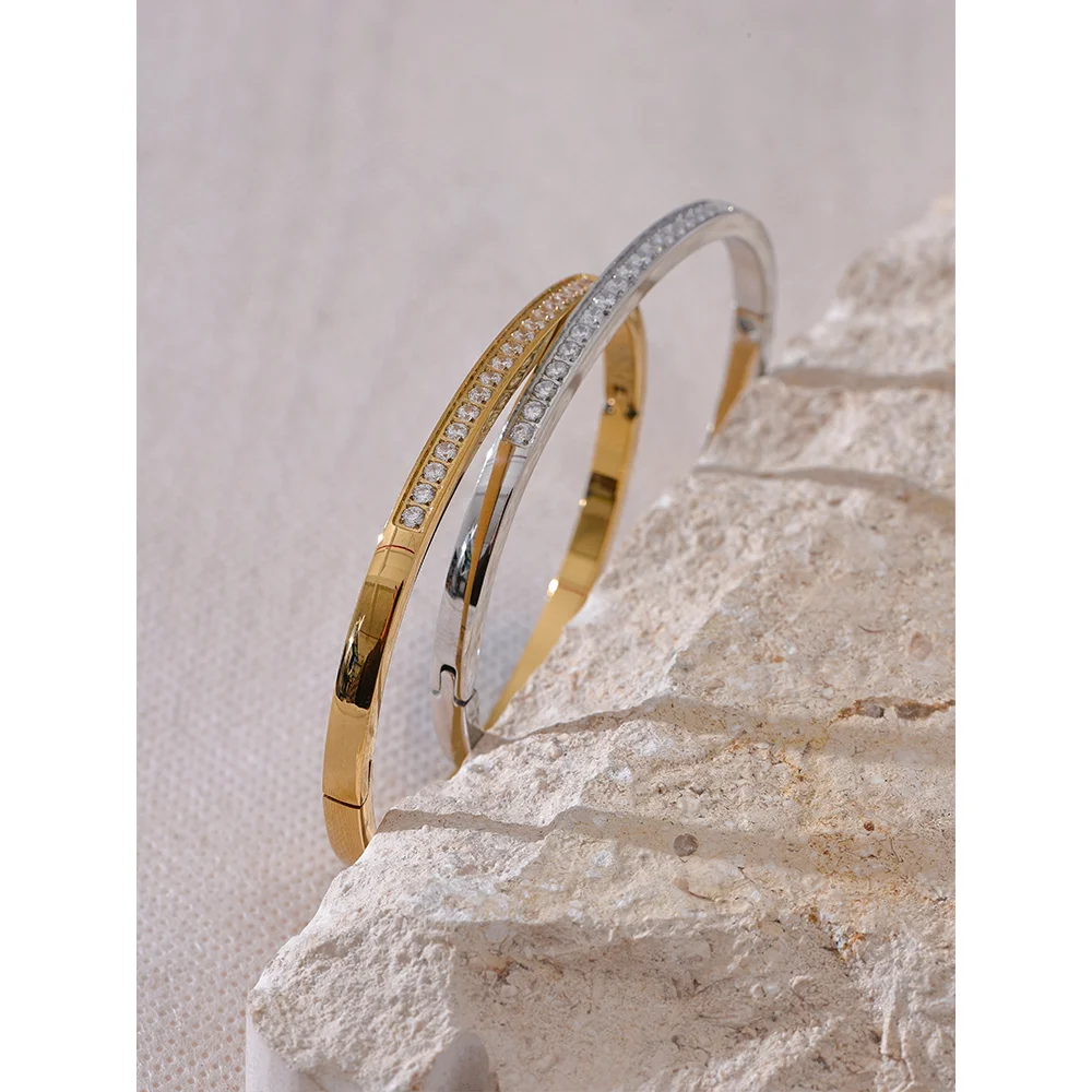 Minimal bangle and bracelet stack showing gold plated warmth