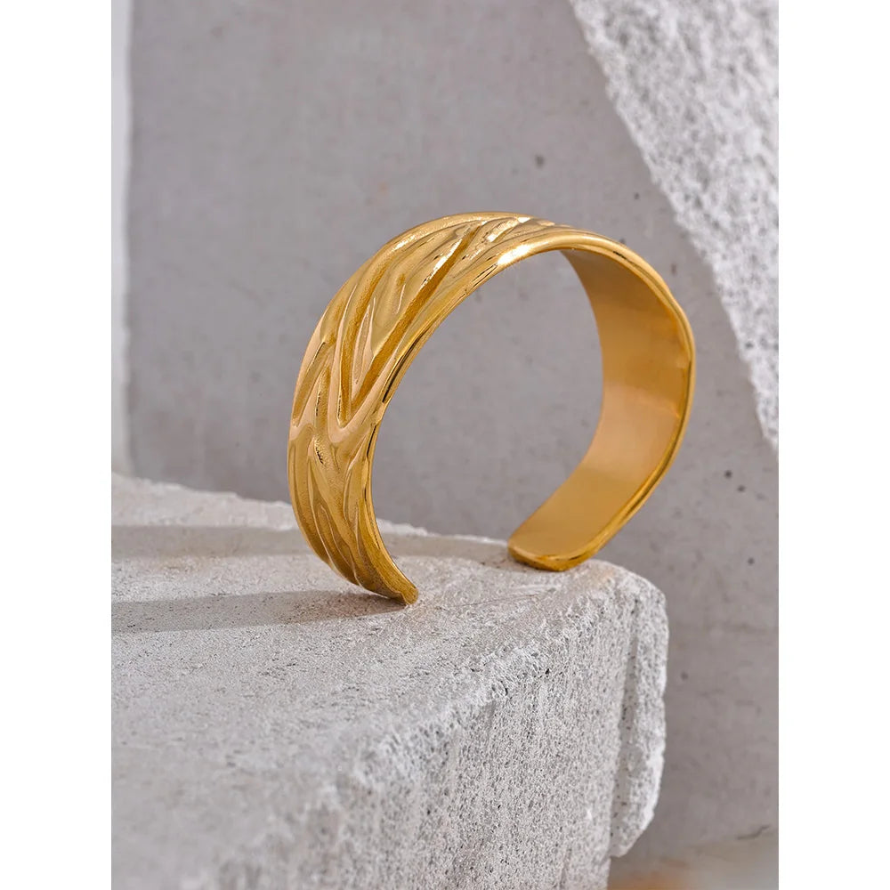 Gold women bracelet shown as a polished bangle bracelet
