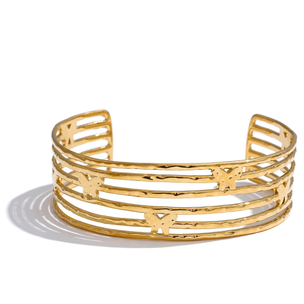 Butterfly bracelet shown as a gold cuff bracelet with gold plated shine