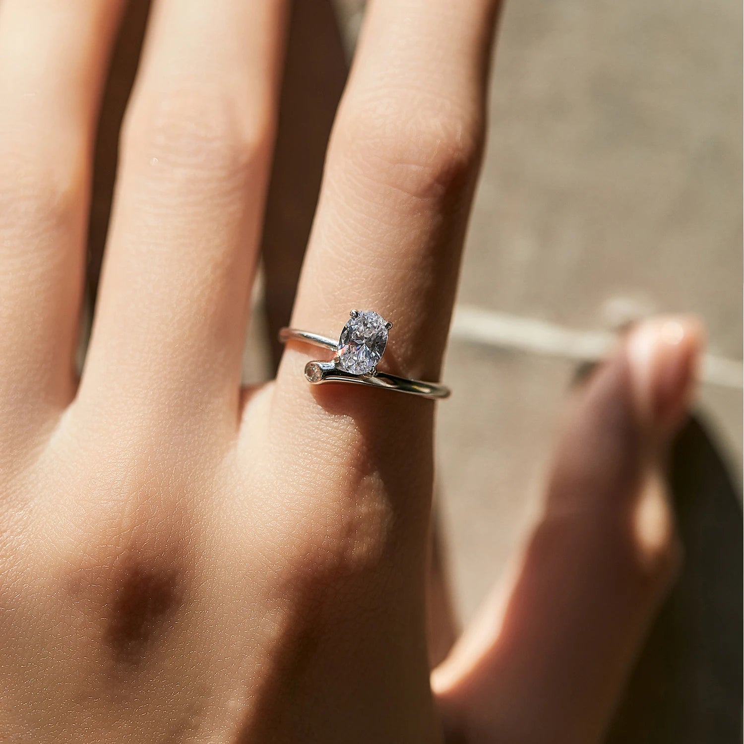 Sterling silver ring with irregular oval zirconia and fluid metal finish