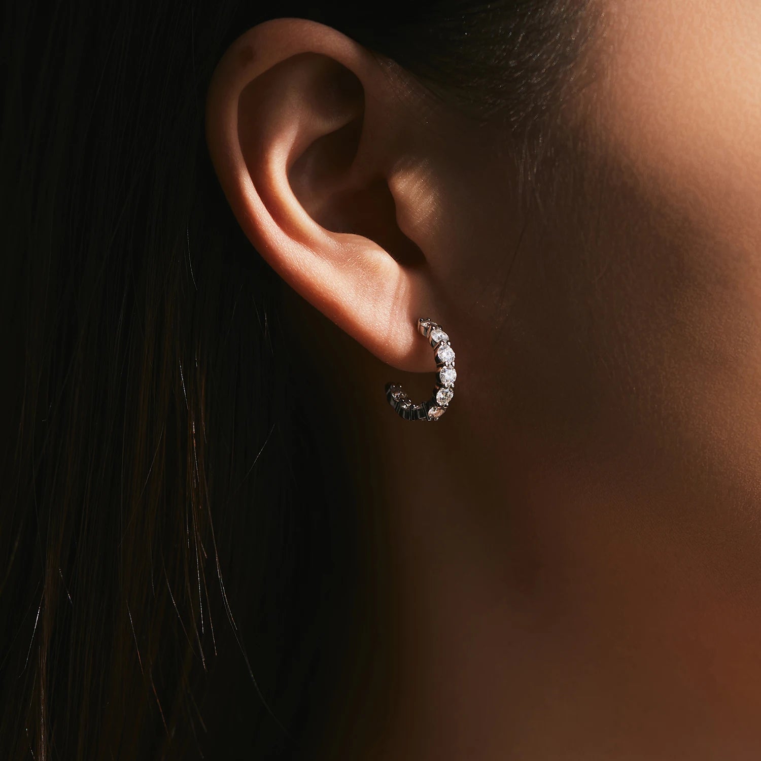 Classic sterling silver hoop earrings styled with moissanite jewelry accents