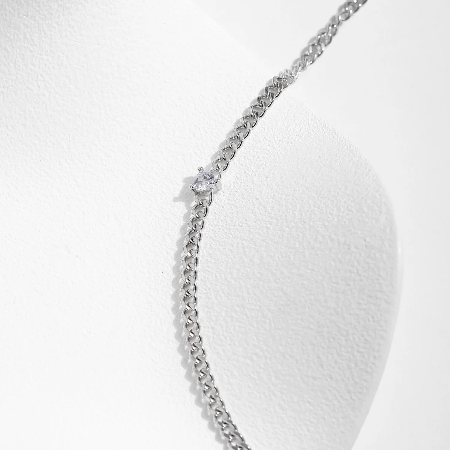 Close view of sterling silver chain bracelet highlighting heart cz sparkle