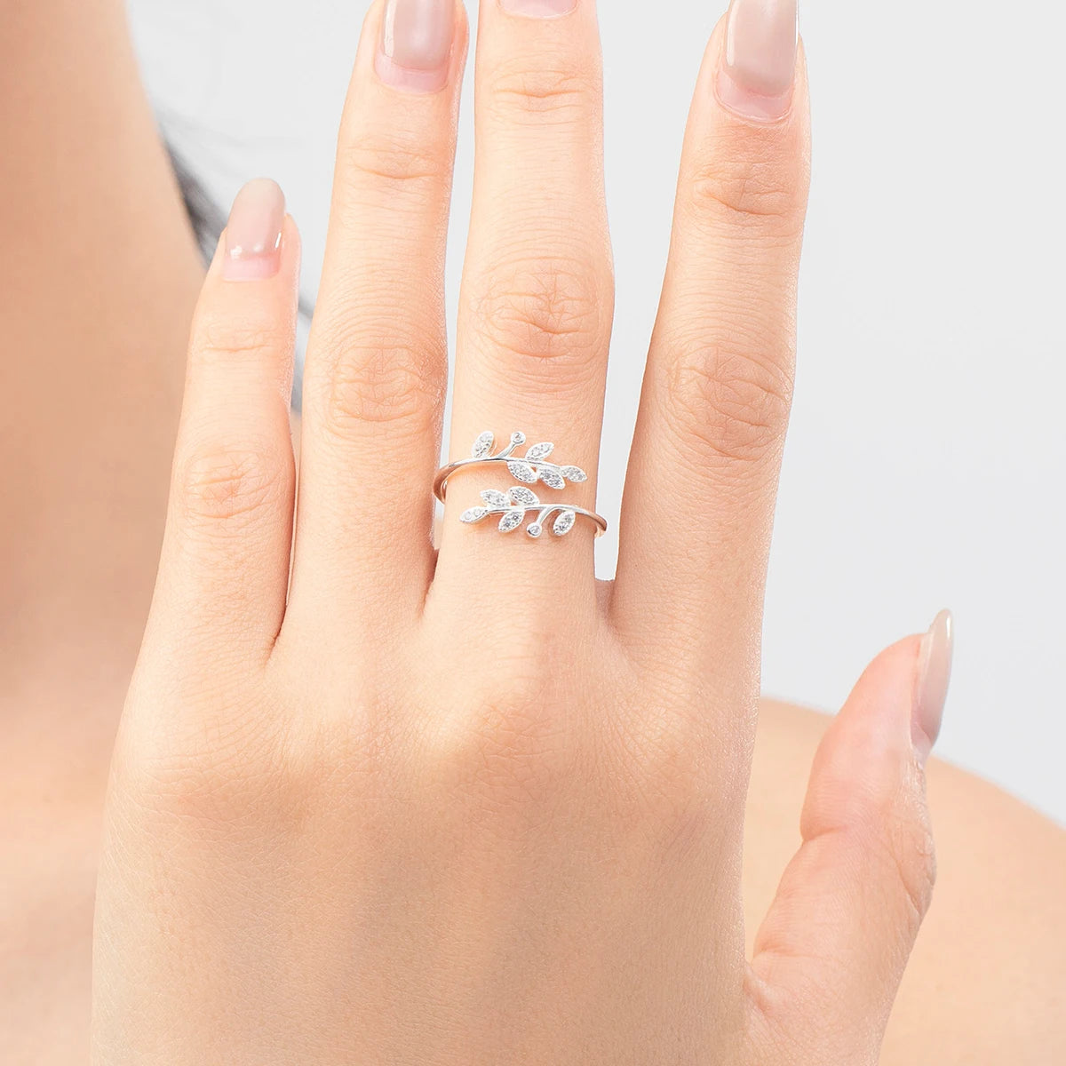 Close up of silver ring featuring a delicate tree leaf CZ accent