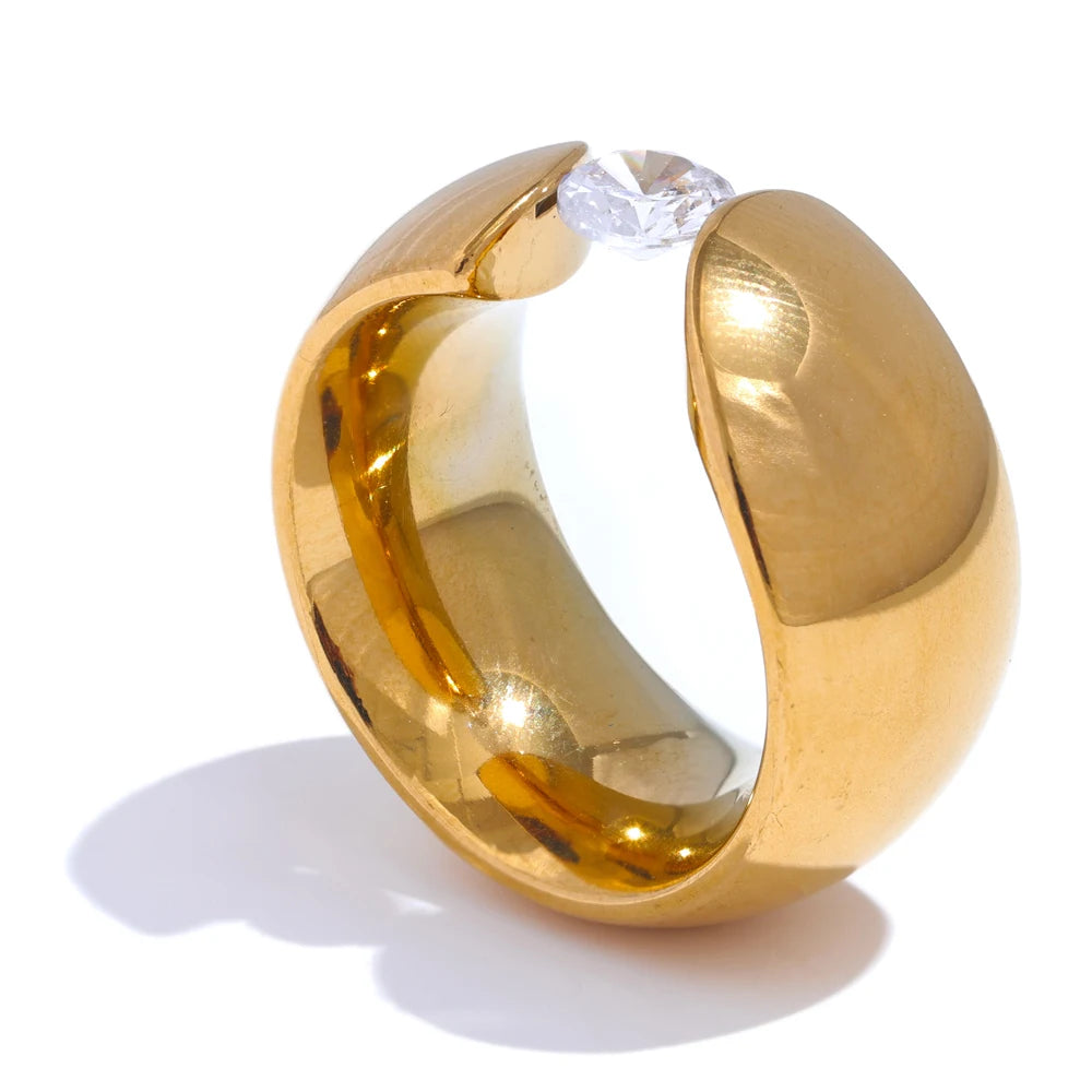 Gold ring with shiny cubic zirconia in a wide gold plated design