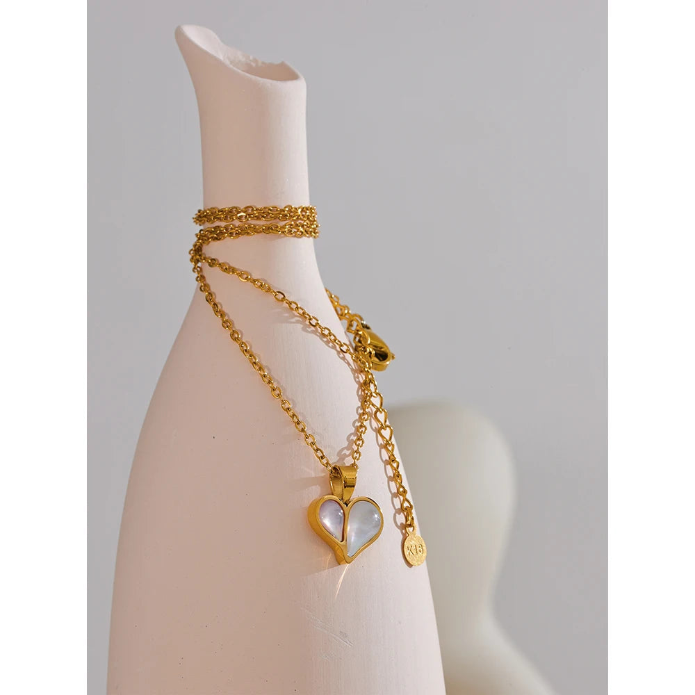 Charm necklace composition with gold heart on a sleek chain