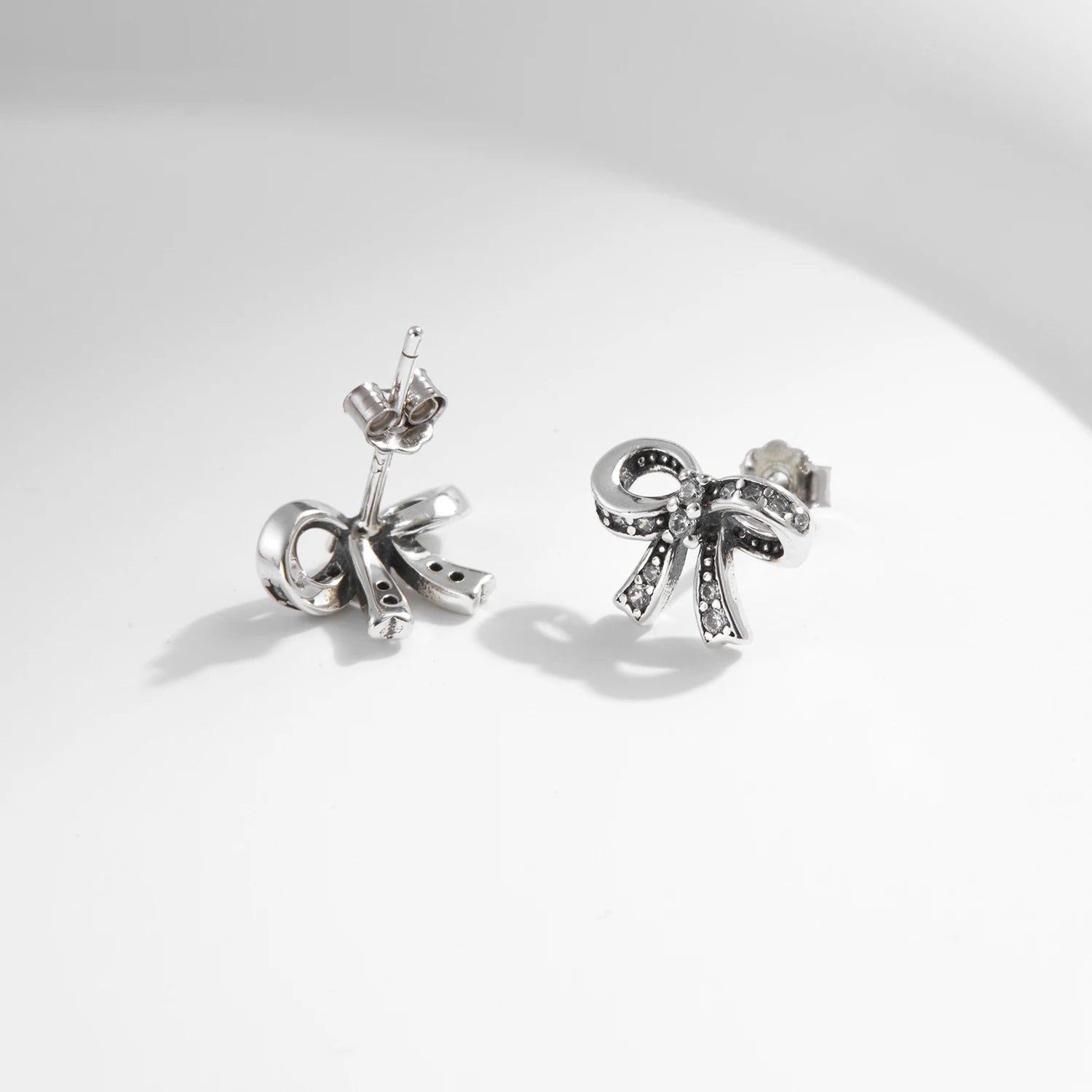 Elegant stud earrings with bowknot motif and dazzling cz in sterling silver