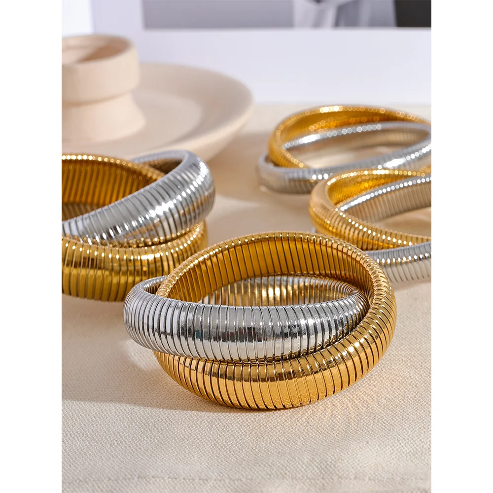 Gold jewelry flat lay featuring a bracelet for gold centerpiece