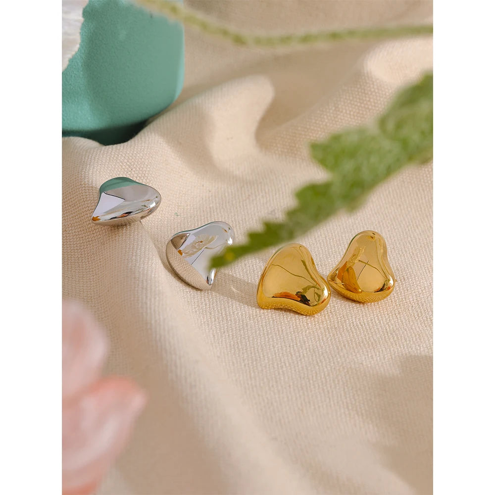 Women wearing gold heart stud earrings gold jewelry