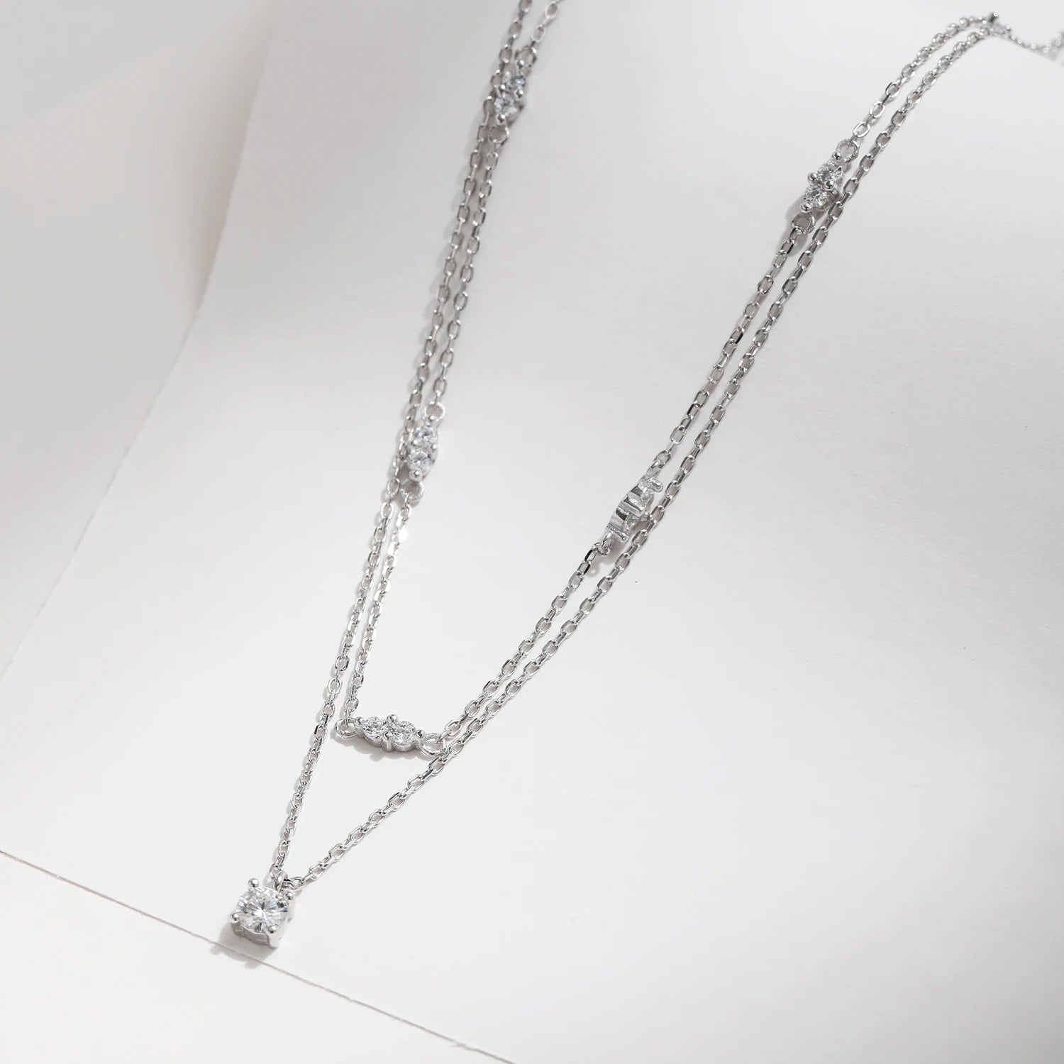 Sterling silver necklace featuring a delicate charm necklace accent