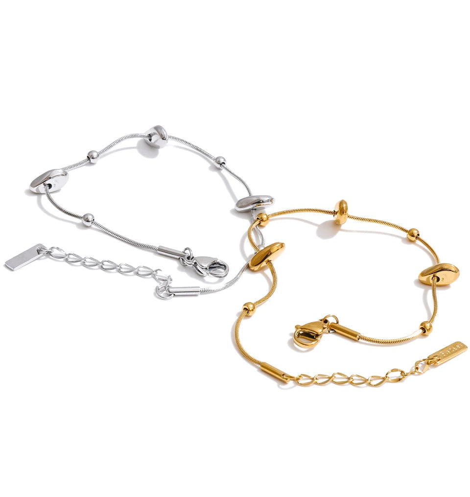 Coordinated gold plated necklace and bracelet duo on model