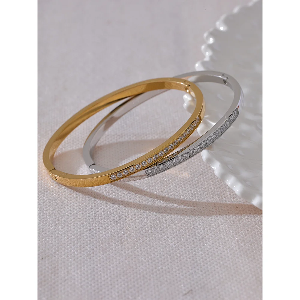 Gold bangle with cubic zirconia set in a polished finish
