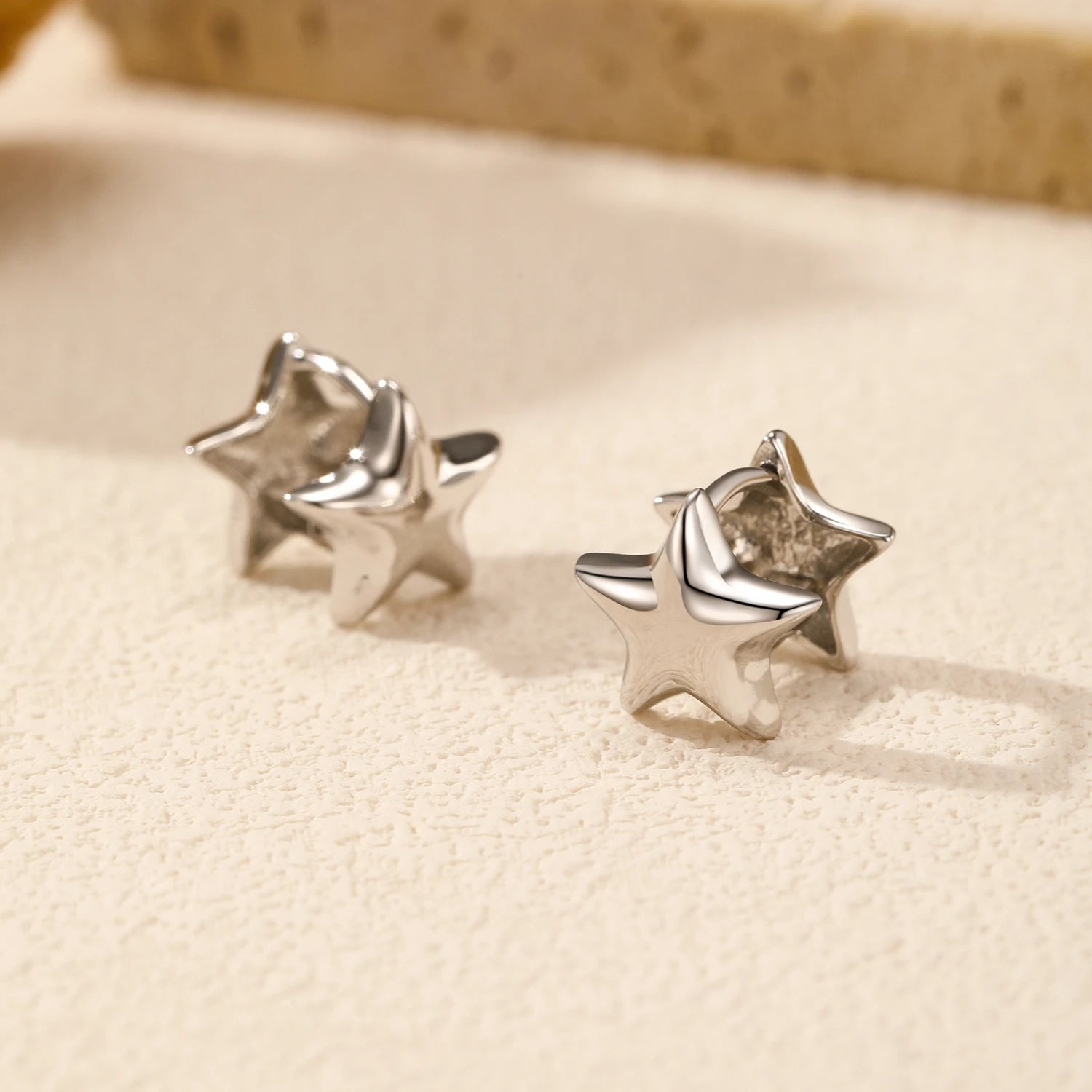 Star earrings in polished sterling silver hoop design