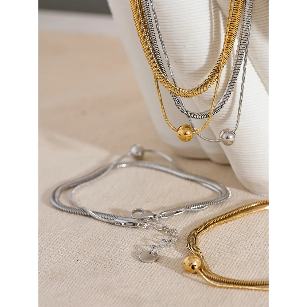 Chain gold chain detail shown with a gold i necklace