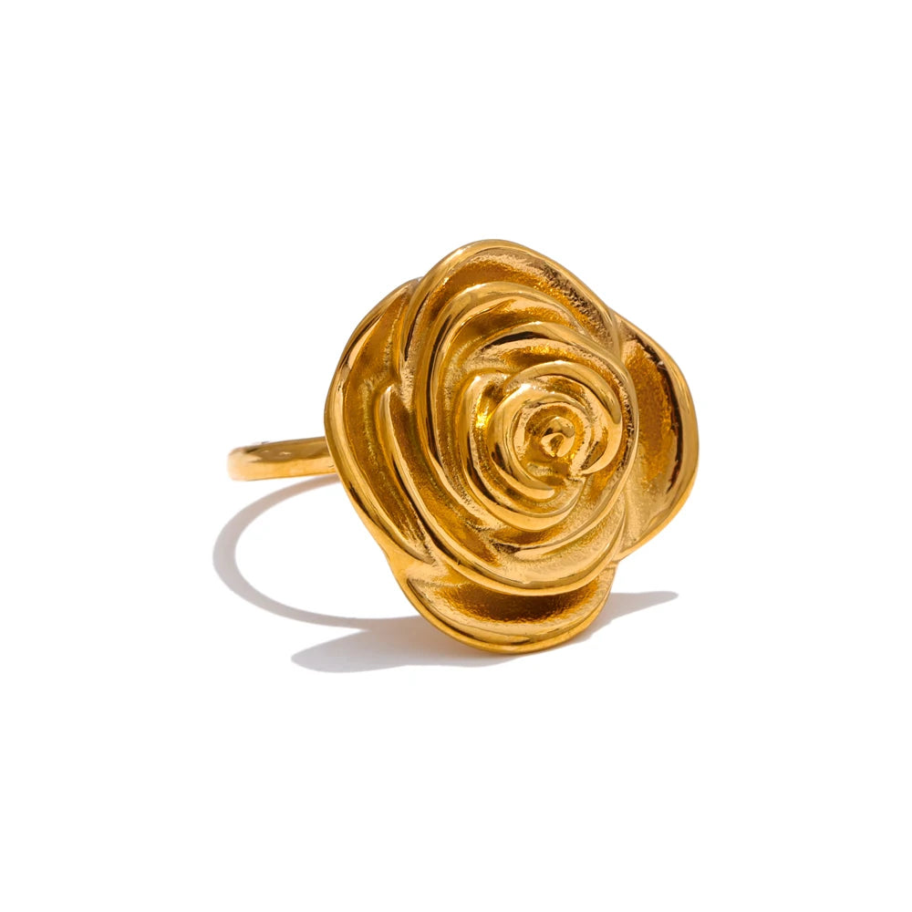 Macro detail of gold in ring surface paired with flower earrings sparkle