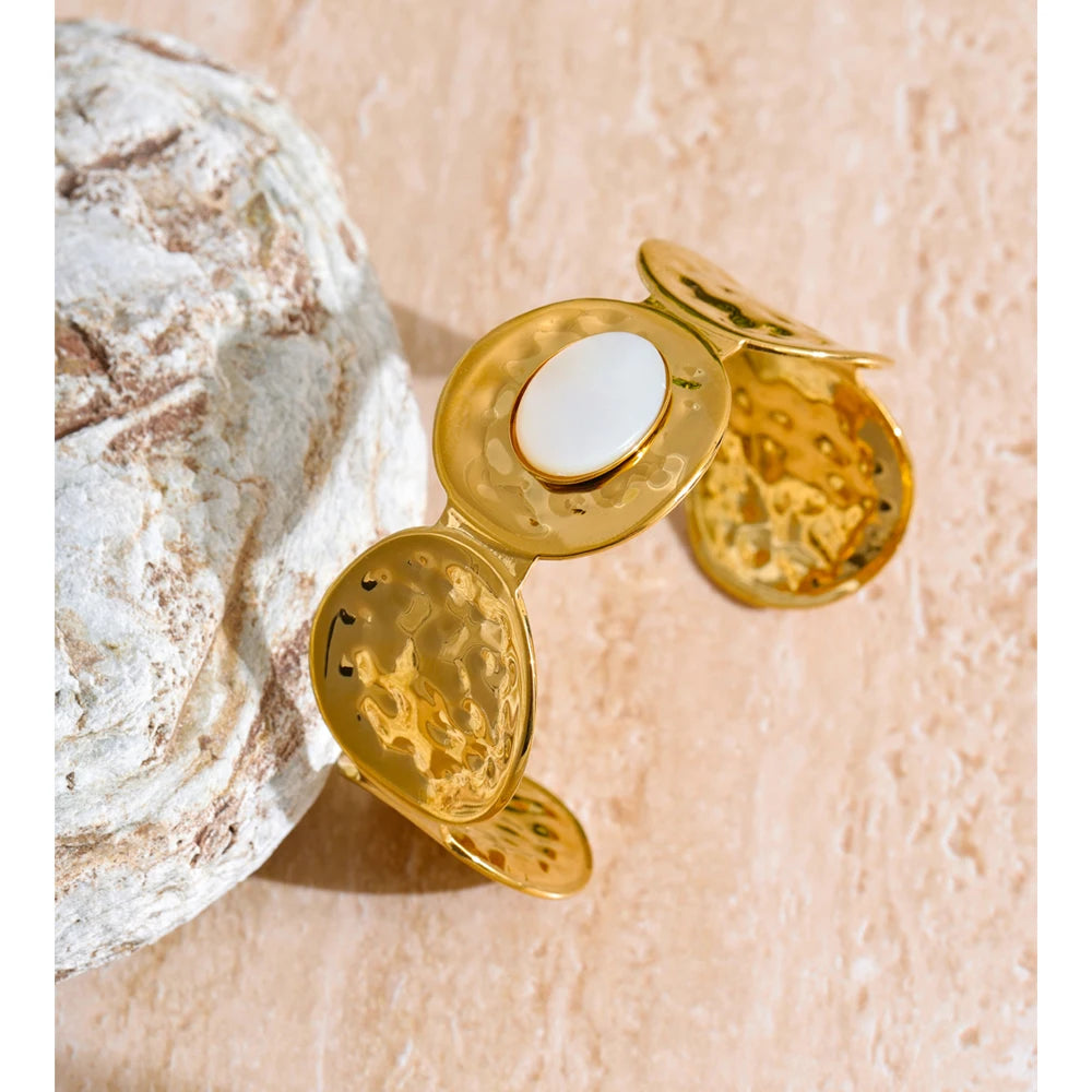 Hammered shell texture captured on open bangle and bangle gold cuff
