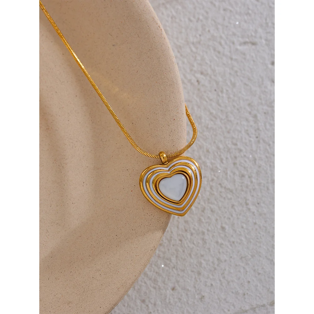 Delicate gold heart accent in gold jewelry with heart shell detail