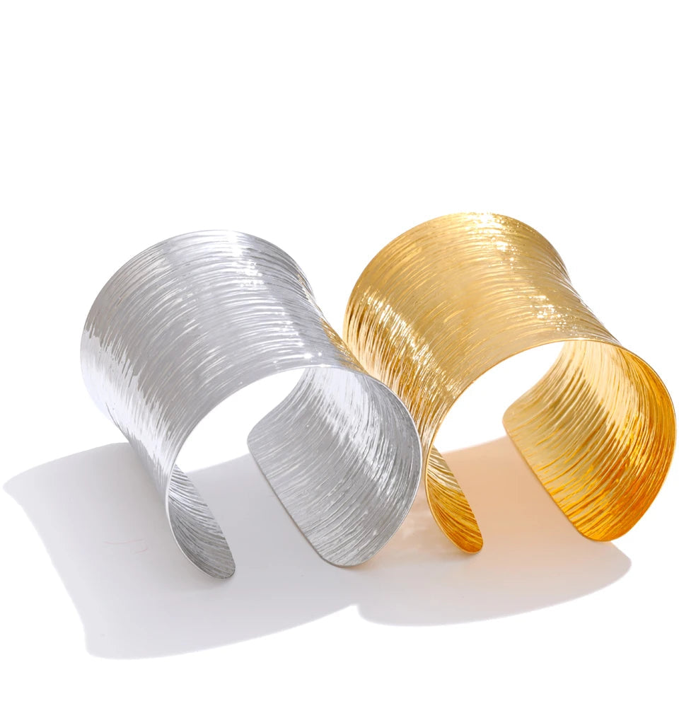 Side angle of wide gold bracelet bangle with subtle texture