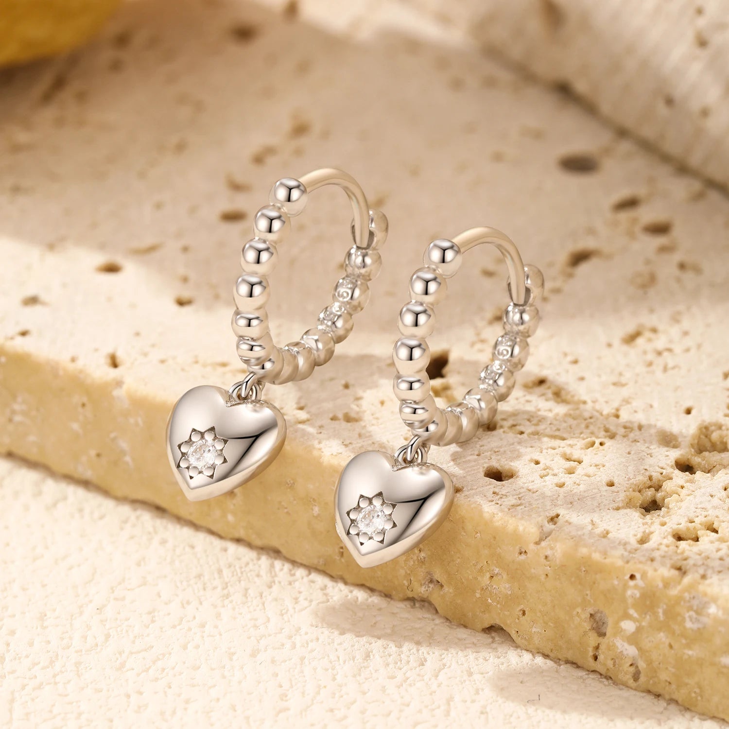 Silver hoop heart earrings crafted as sterling silver earrings