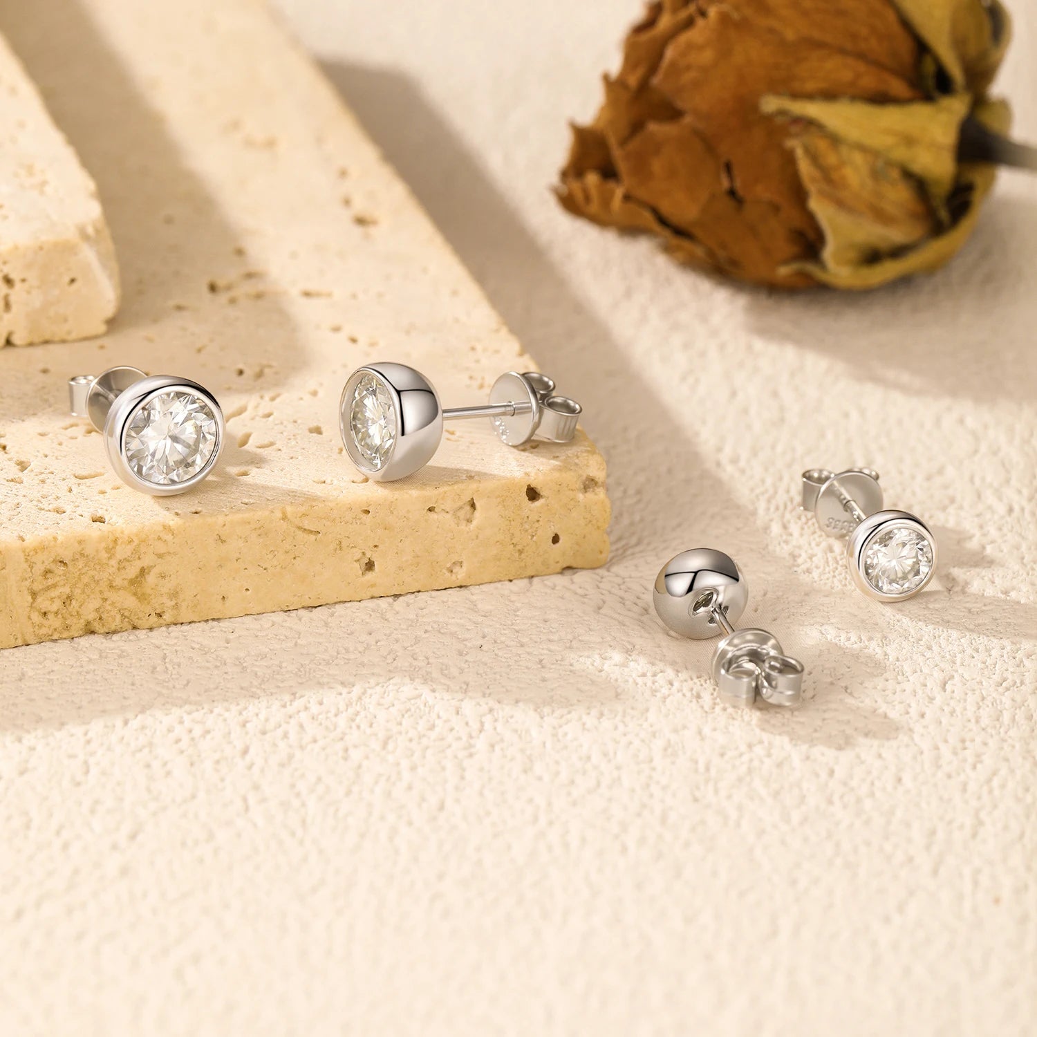 Classic diamond earrings look created with bezel moissanite